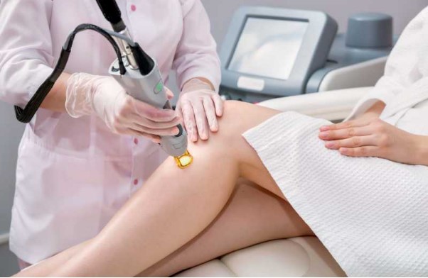 Woman getting laser hair removal on her legs