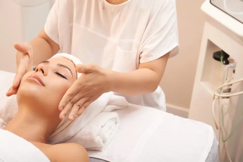 Microneedling with exosomes - woman's face massaged