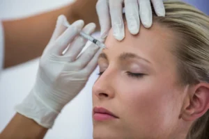 Female patient receiving botox treatment on her forehead