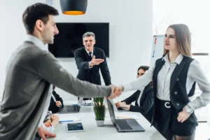 People shaking hands in franchise meeting