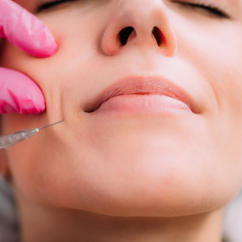 Woman getting cosmetic injectable in her cheek