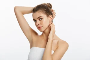 Woman holding arms up to face showing underarms