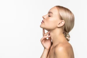 woman with fingers on neck thinking about dermal fillers