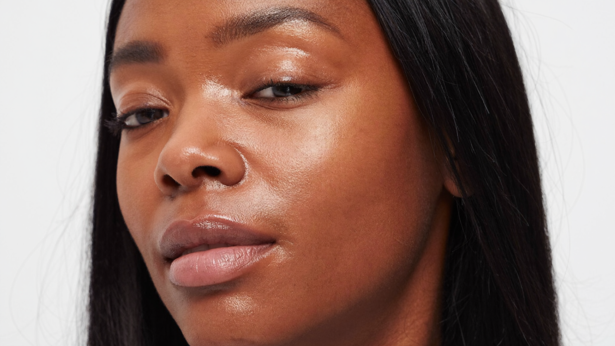 Woman with deep skin tone with healthy glowing skin and a refreshed under-eye area after PRF treatment